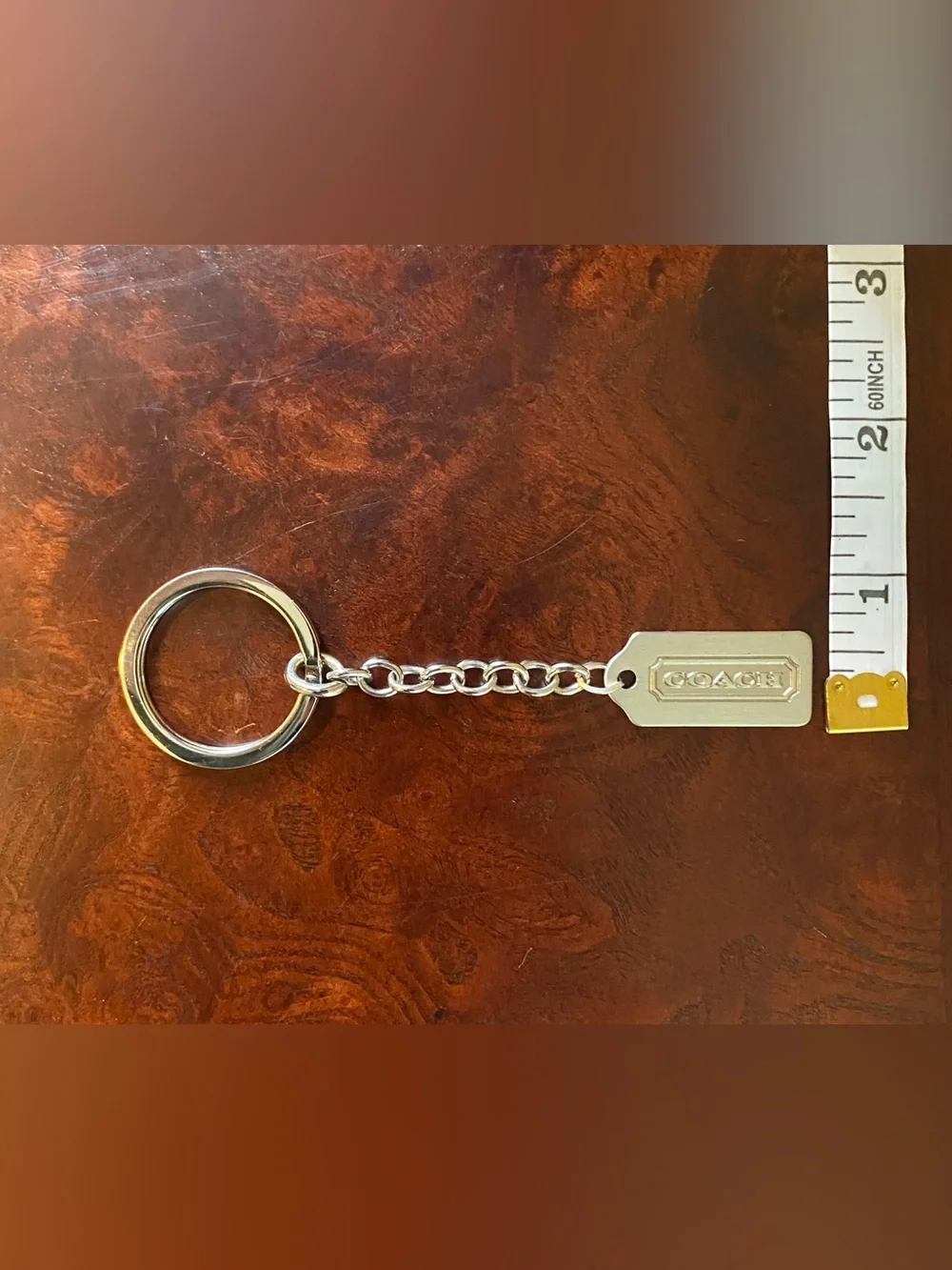 Coach metal tag